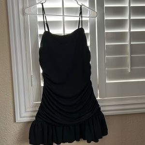 A black dress with cute ruffles and shape to the body